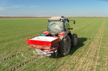  tractor fertilizing in field