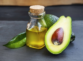Avocado oil in bottle with avocado fruit - 103491941
