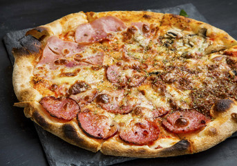Pizza quatro stagione with salami, ham,chicken and cheese