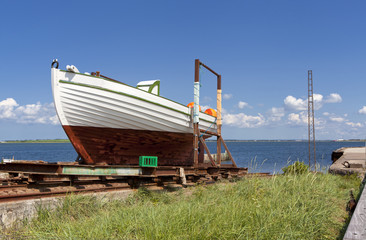 Fototapeta na wymiar Ship on the grass near the sea in Denmark, Limfjord
