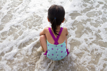 Asian Little Chinese Girl Sitting on the Beach