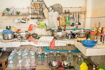 untidy Kitchenware ; Pile of dirty dishes in sink and counter in the kitchen