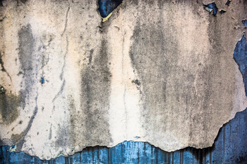 Old damaged whitewash on the concrete wall with rich texture