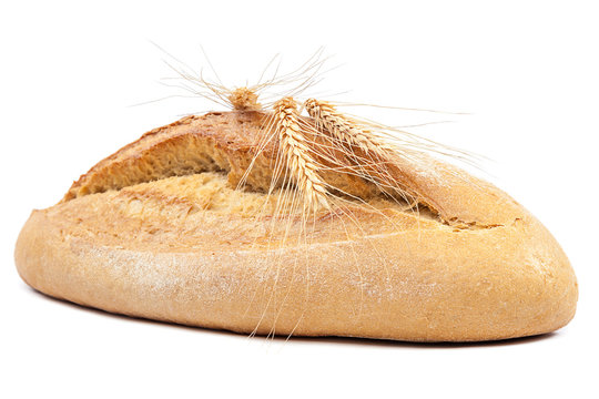 Loaf of bread and wheat ears.