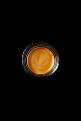 Glass of espresso on a black background