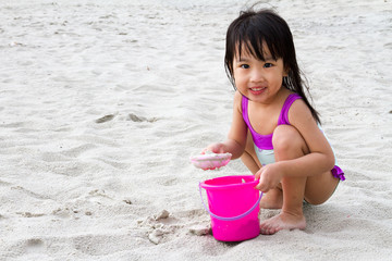 Asian Little Chinese Girl Playing Sand with Beach Toys
