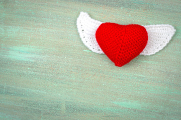 heart crocheted from threads, red, white, blue, purple, yellow,