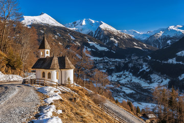 Chapel in the mountains overlooking the town of Bad Gastein. Austrian Alps.