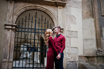 Young beautiful stylish fashion couple in a red dress in love st