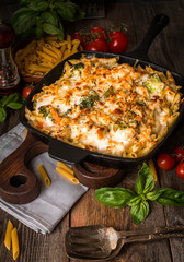 Baked pasta with broccoli, cauliflower, cheese and bechamel sauc