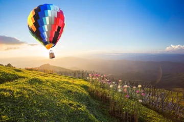 Behangcirkel Hot air balloon over the mountain © littlestocker