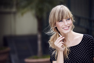 Young woman smiling as she communicates with earphones and mic