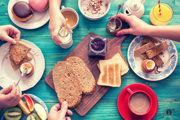 Young Happy Family Having Breakfast