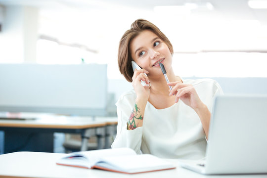 Woman talking on the phone in office