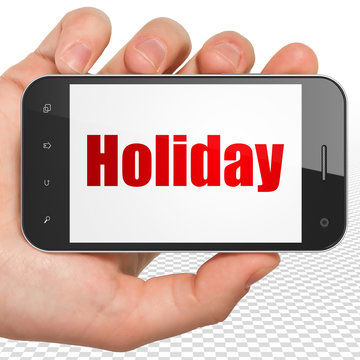 Tourism concept: Hand Holding Smartphone with Holiday on display