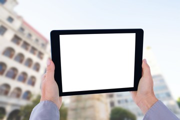 Composite image of cropped hand of man holding digital tablet
