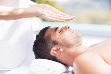 Fototapeta na wymiar Man receiving a head massage from masseur