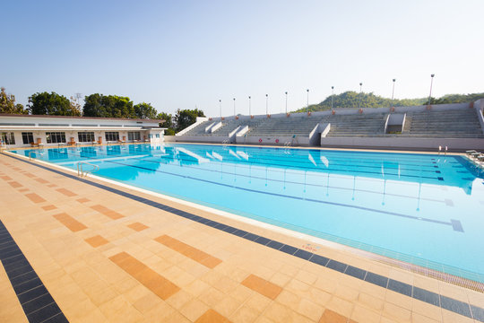 empty swimming pool in sunny day, wide shot, horizontal