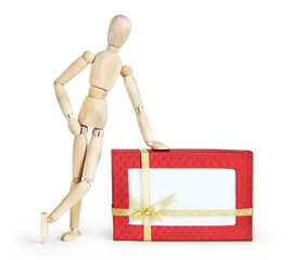 Man with the huge gift box. Abstract image with a wooden puppet