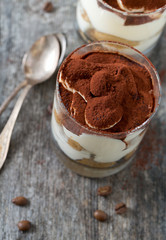 tiramisu in glass on wooden surface
