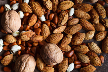 Mixed nuts on wooden background