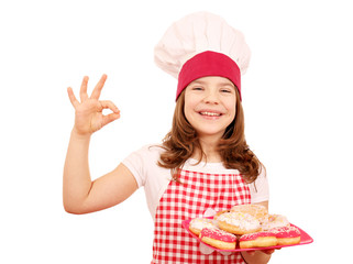 happy little girl cook with donuts and ok hand sign