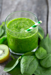 fresh green smoothie on wooden surface