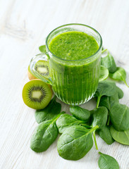 fresh green smoothie on wooden surface