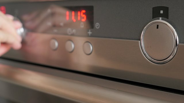 Programming modern oven for cooking food 4K 2160p UltraHD footage - Cooking contemporary  oven setting dials for temperature and program 4K 3840X2160 UHD video