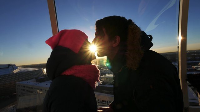 couple kissing  on sunlight inside the capsule at Ericsson Globe, the national indoor arena of Sweden