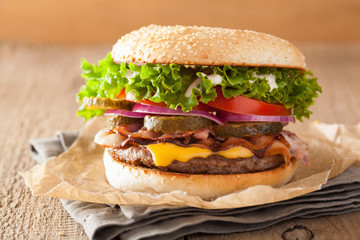 bacon cheese burger with pickles tomato onion