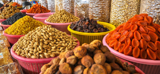 Dried fruits and nuts in the Uzbek market - obrazy, fototapety, plakaty