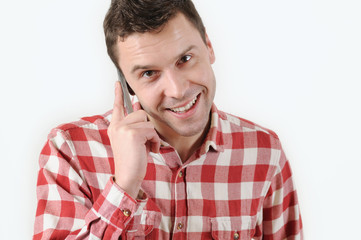 handsome man talking on his mobile phone against a white background
