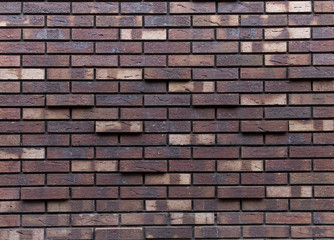 Texture of brown and beige brick wall.
