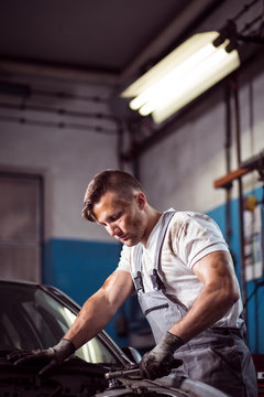 Man repairing car in garage