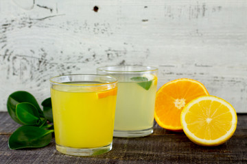 Citrus juices with fresh fruit on wooden table