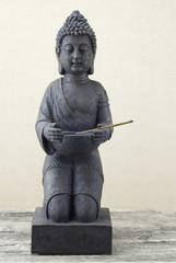 Statue of Buddha with incense stick