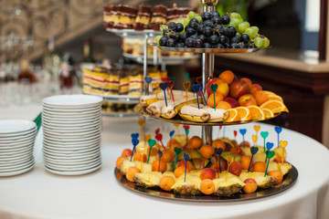 stylish luxury golden decorated table with sweets and fruits for