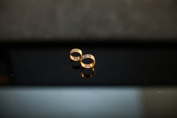 gorgeous luxury golden pair of wedding ring on black background