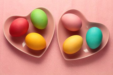 Painted easter eggs in a heart shaped bowls