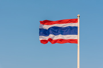 Fototapeta na wymiar Image of waving Thai flag of Thailand with blue sky background.
