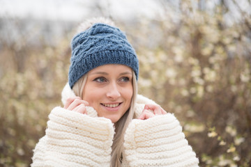 portrait of girl holding her jumper and looking in 