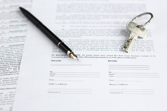 Legal Document For Sale Of Real Estate, With A Gold-nibbed Fountain Pen And House Keys