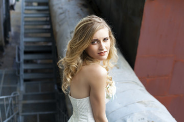 Fototapeta premium Young beautiful blonde woman in bridal dress