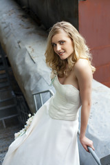 Young beautiful blonde woman in bridal dress