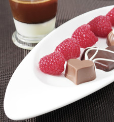 Assorted chocolate candies with raspberries