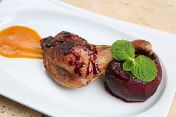 Roasted duck leg baked with apple in red wine