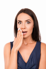 Fototapeta premium Portrait of surprised shy young woman on white background