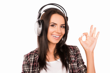 Portrait of young smiling girl with head-phones listening music