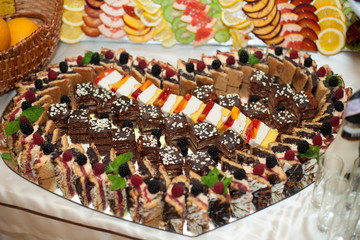 stylish luxury decorated tables with sweets for a wedding of hap